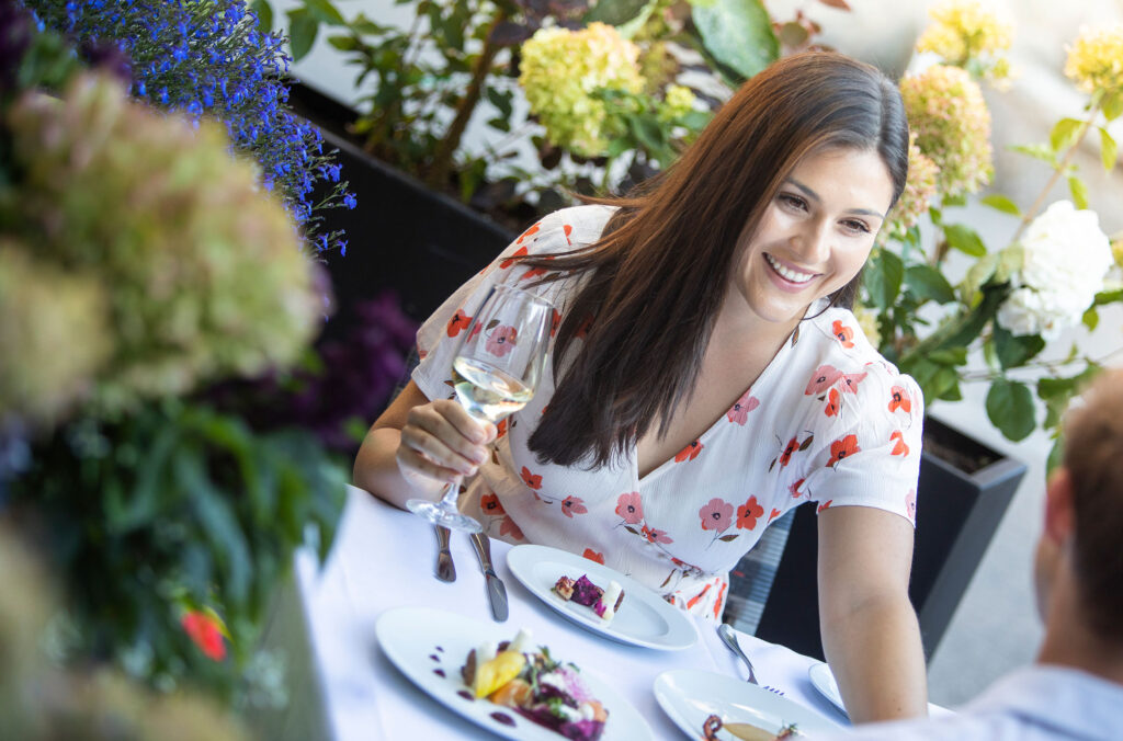 A couple enjoy dinner on the Araxi patio in Whistler.