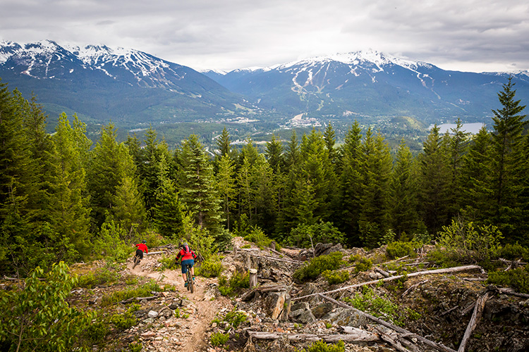 Mountain bikers riding towards Whistler and Blackcomb Mountains