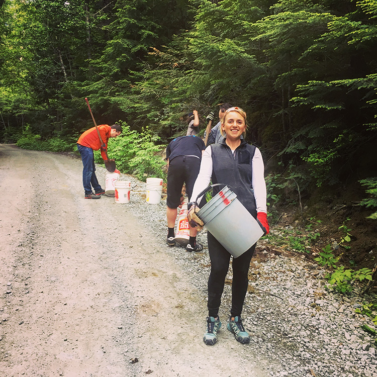 Woman working on a mountain bike trail in Whistler