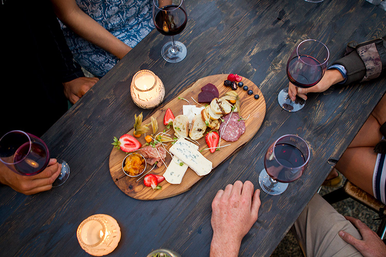 Friends sharing a charcuterie board in Whistler