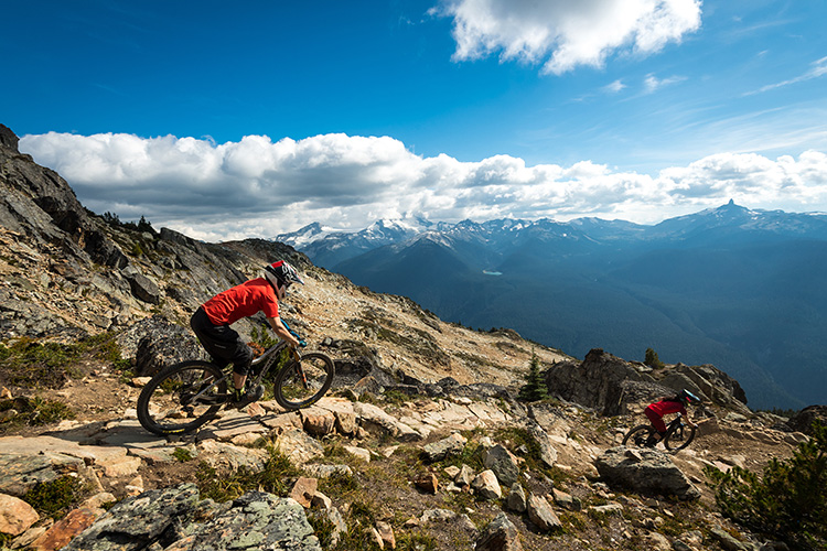 Two bikers on the Top Of The World trail in Whistler