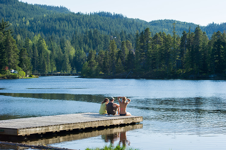 People sitting on a dock at Alpha Lake