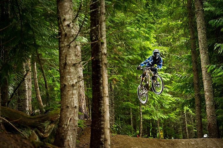 Mountain Biker on jump in Whistler Mountain Bike Park