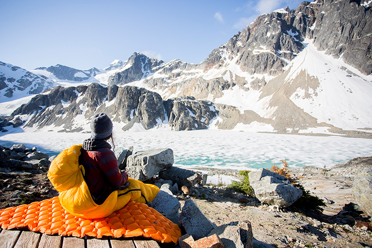 Camper in sleeping bag at Wedgemount Lake