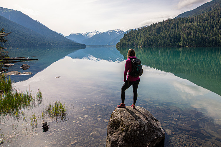 Hiker standing on a rock at Cheakamus Lake