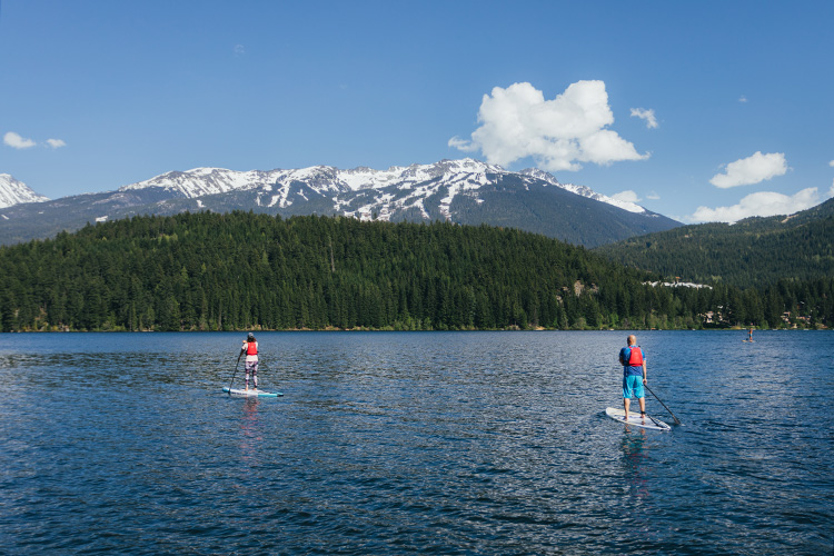 Guide and guest on a paddleboard tour in Whistler