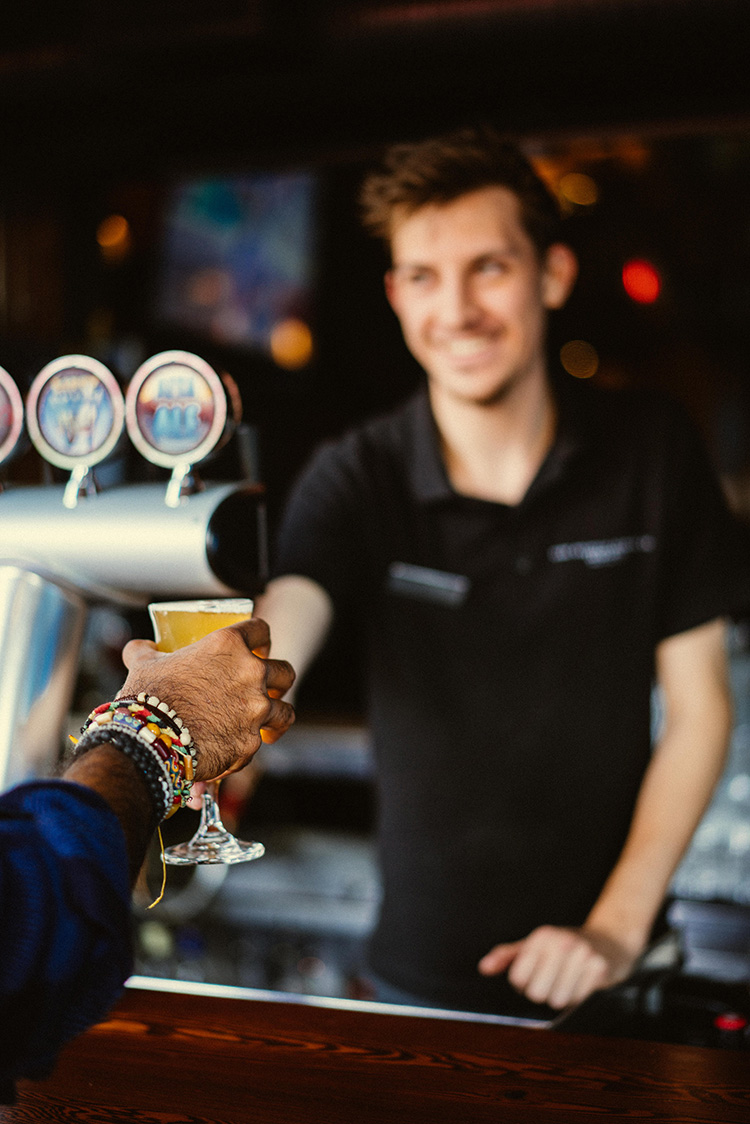 Highmontain Brewing bartender handing over a beer