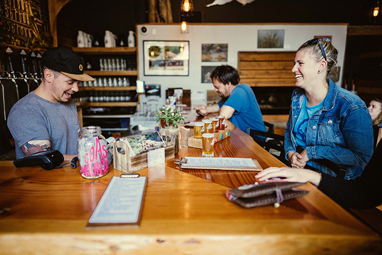 Bartender serving patron at Coast Mountain Brewering