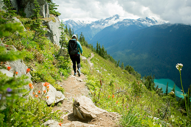 Hike on hiking trail overlooking lake on Whistler Mountain