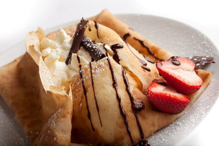 Pastry dish with whip cream and strawberries