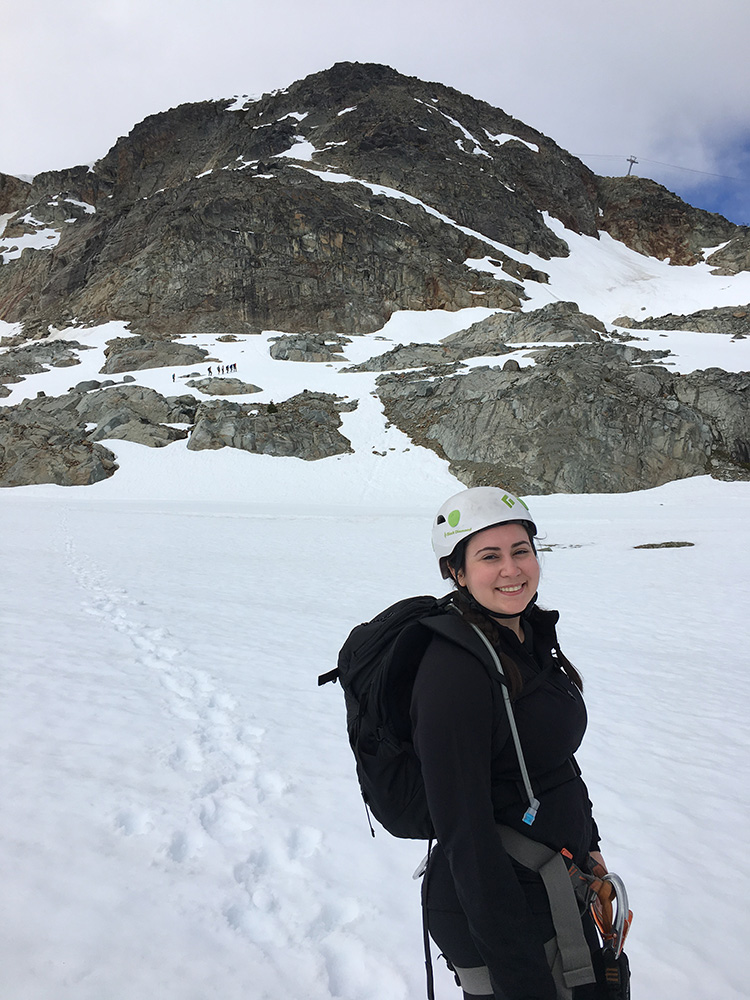 Guest on the Via Ferrata Tour smiling in front of mountain