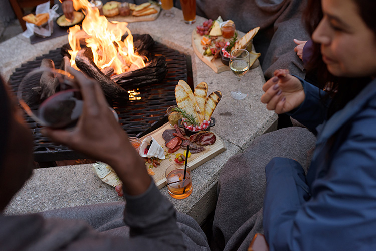 People eating around a firepit in Whistler