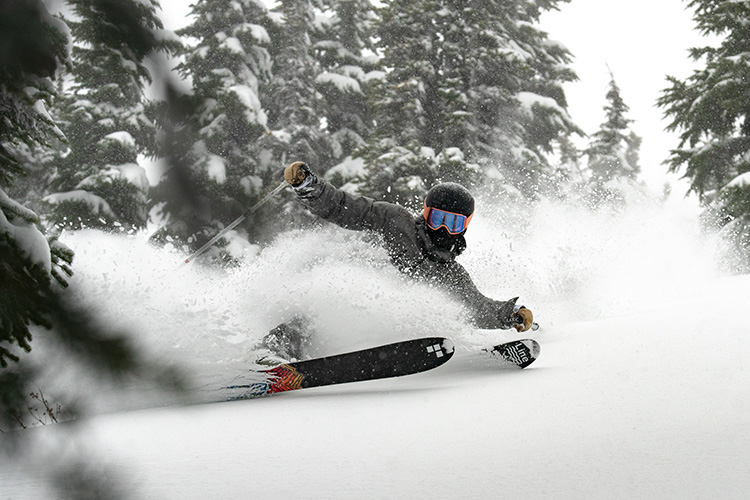 Skiier in powder conditions on Whistler Mountain