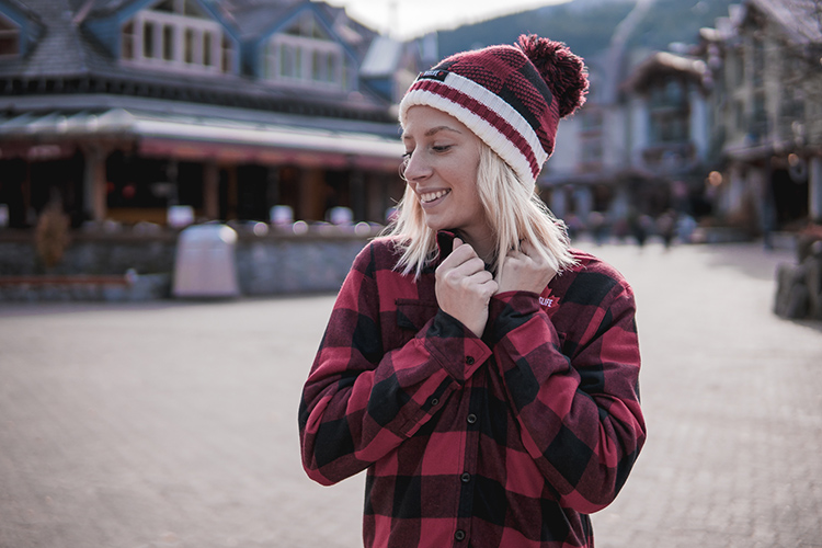 Woman wearing a plaid shirt in Whistler Village