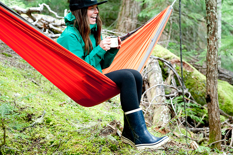 Person in hammock with coffee