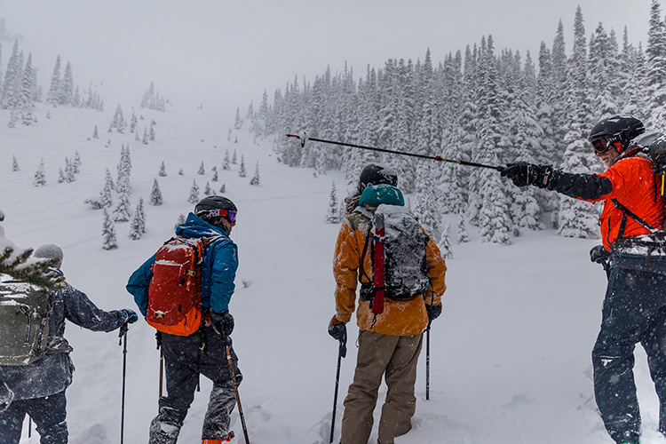 Group talking at base of mountain on an AST 2 course in Whistler