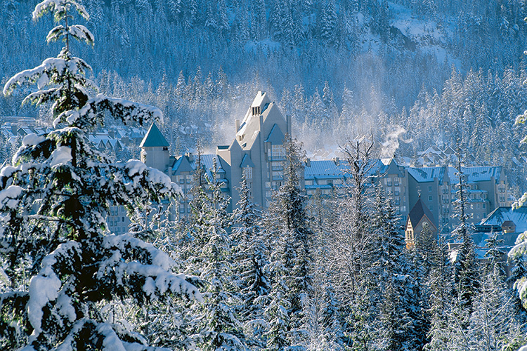 Fairmont Chateau in Whistler surrounded by snowy trees