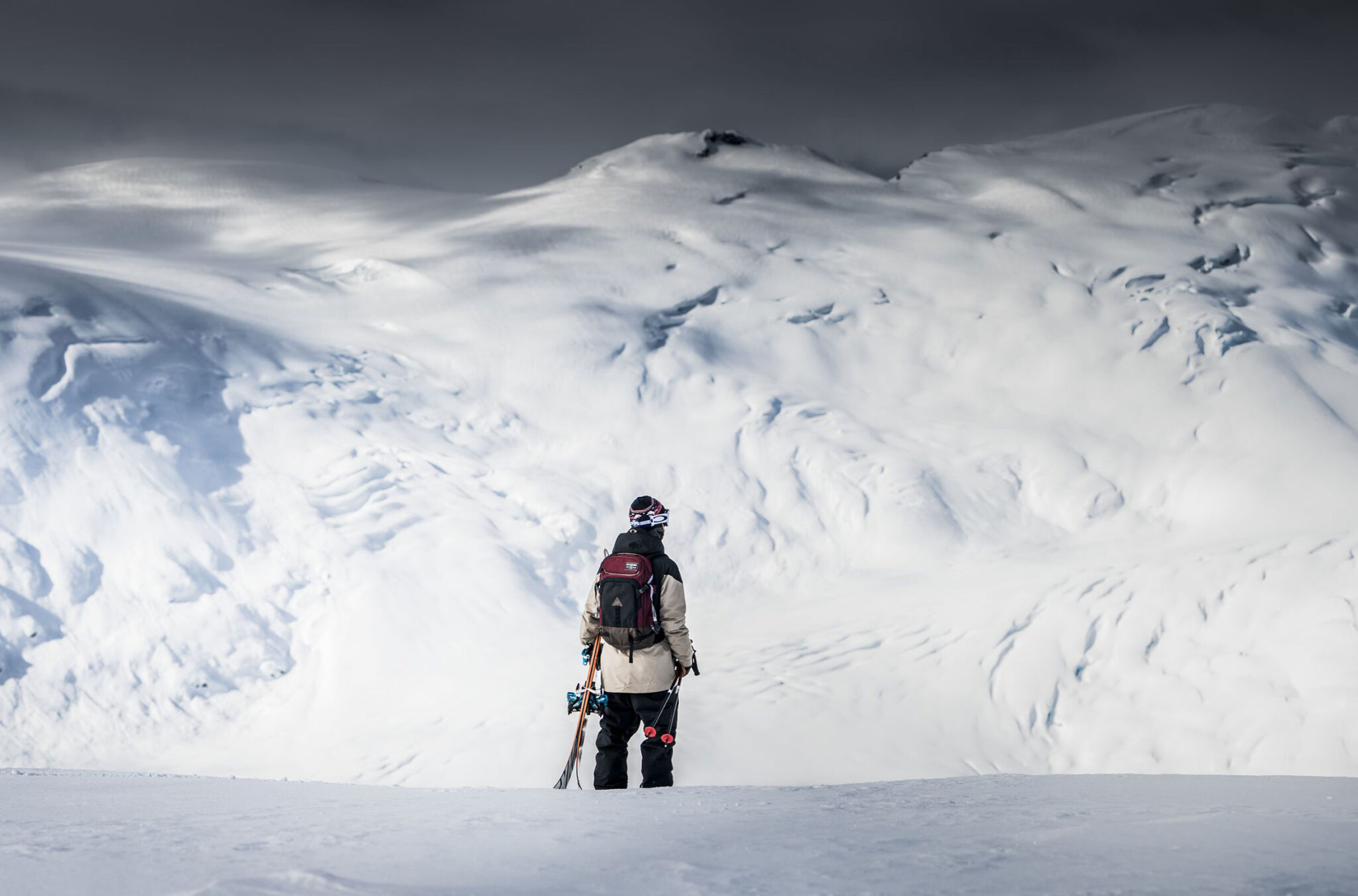 A snowboarder looks out over Whistler's incredible coastal mountain range.