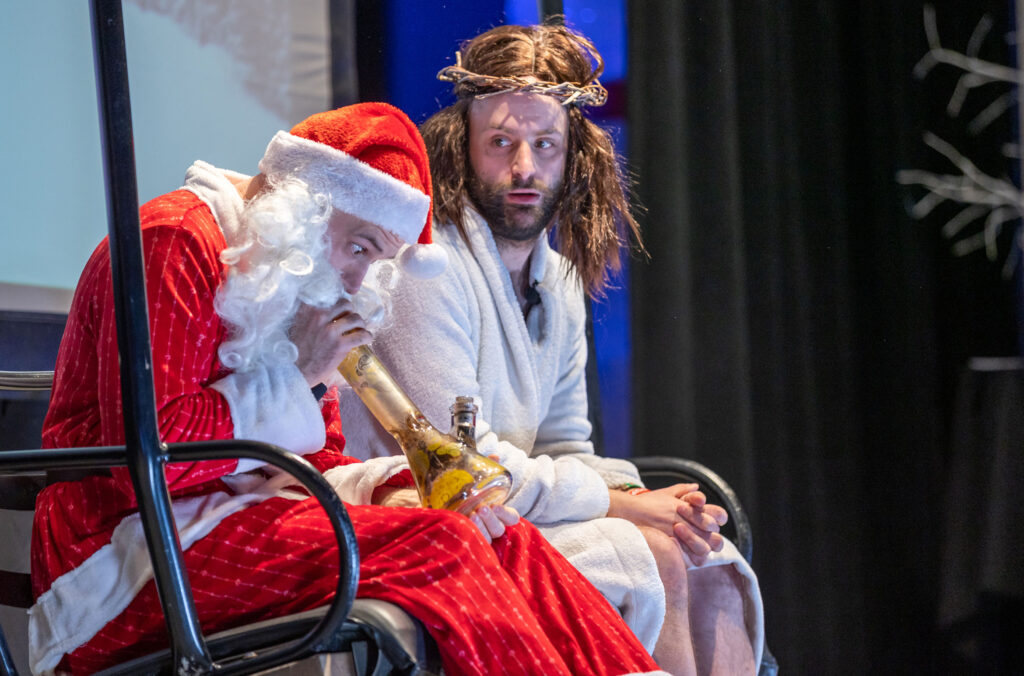 Jesus and Santa sit on a chair lift as part of a sketch at the Laugh Out LIVE! comedy show in Whistler.