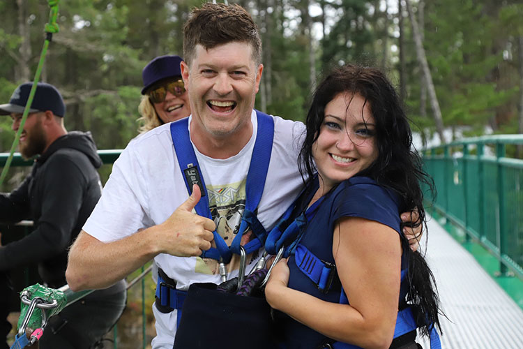 A couple smiles after leaping off the bridge at Whistler Bungee.