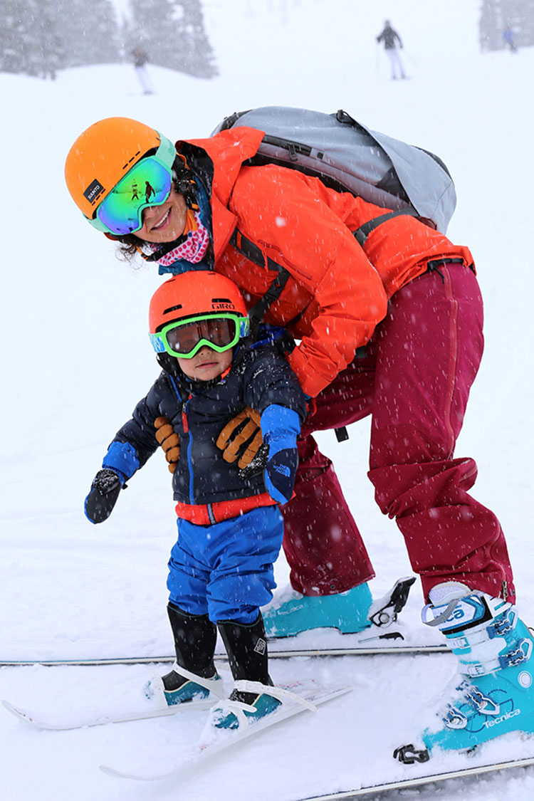 A toddler skis with his mum in Whistler.