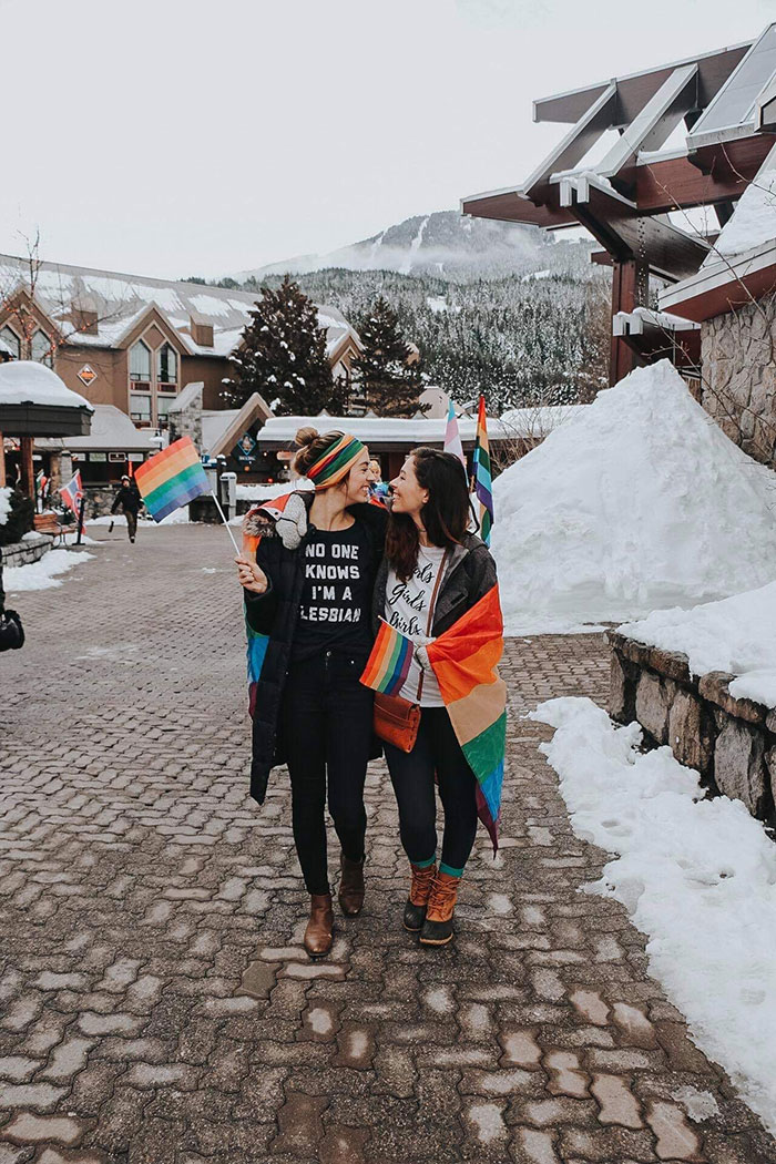 Allie and Sam walk through Whistler Village in the Pride Parade