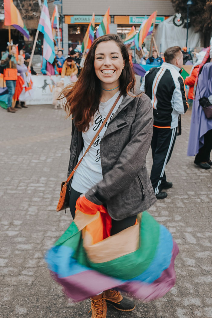 Allie dances with her rainbow flag in Whistler Village