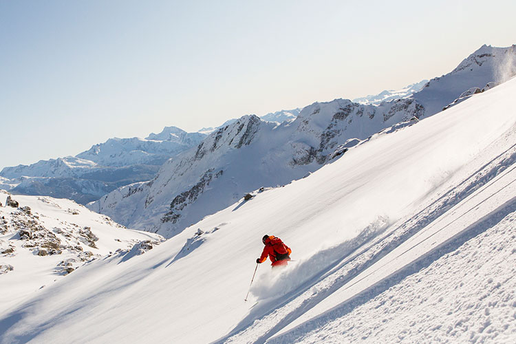 A skier tackles the powder with Whistler Heli-Skiing