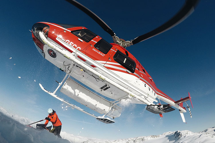 The helicopter lifts off after dropping skiers for Whistler Heli-skiing