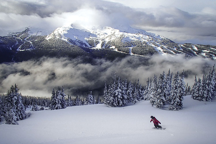 Snowboarder enjoying powder on cloud nine