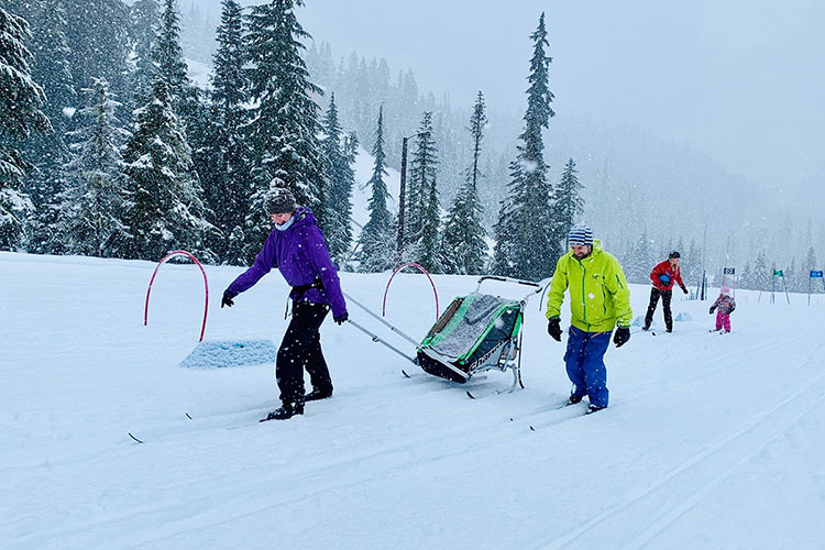 A family enjoy cross country skiing at Whistler Olympic Park.
