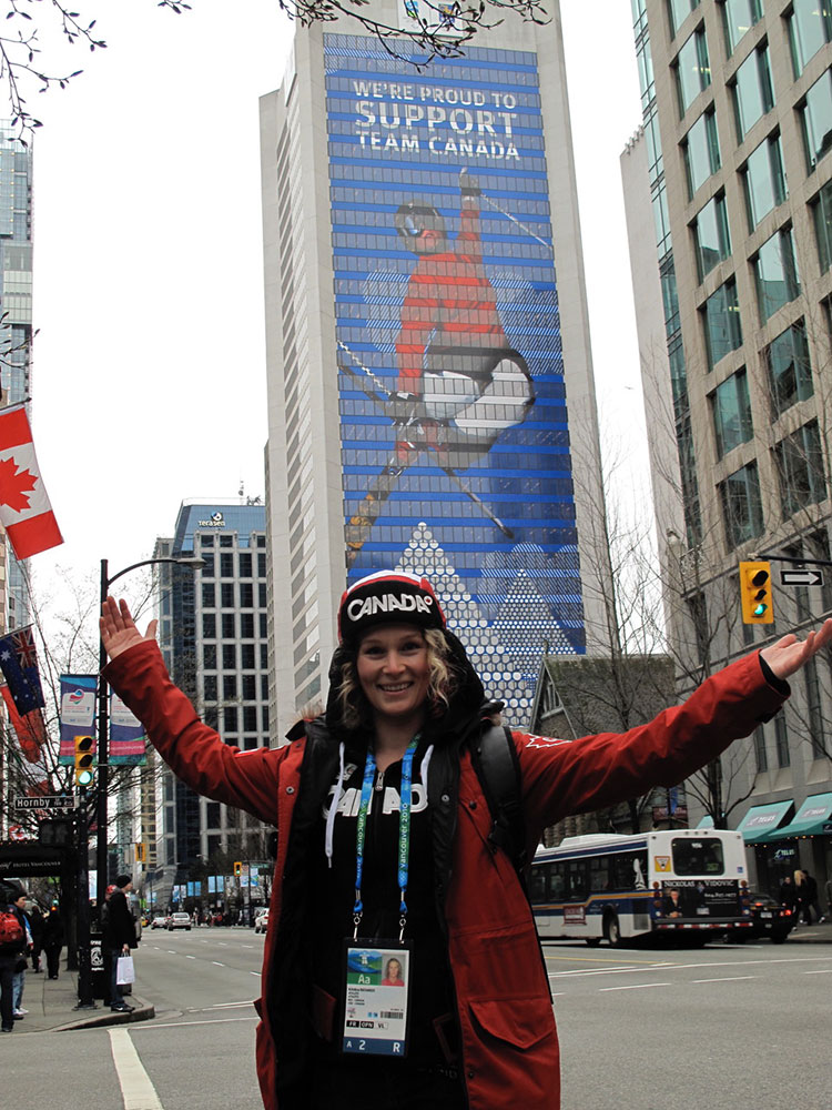 Kristi Richards in Vancouver next to a building wrapped with her image.