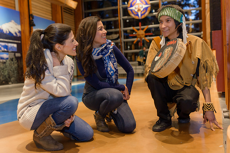 Ambassador talking to guests at the Squamish Lil'wat Cultural Centre