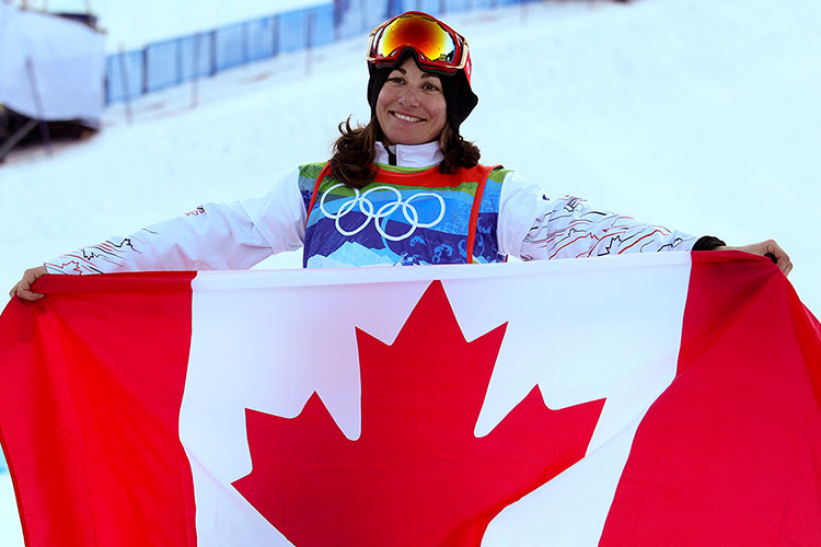 Maelle Ricker holds the Canadian flag as she celebrates her winning run at the 2010 Olympic Winter Games.