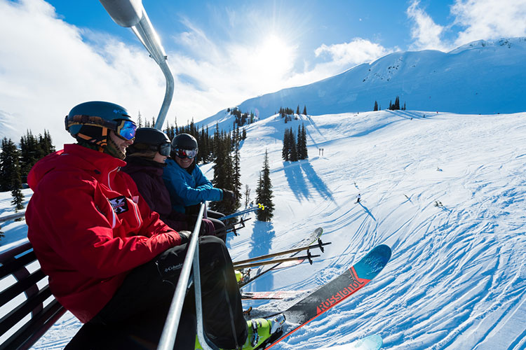 Three skiers ride a chairlift on Whistler Blackcomb and chat about their new run.