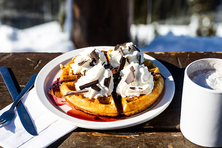 A Belgium waffle topped with cream, maple syrup and chocolate at the Crystal Hut on Whistler Blackcomb.