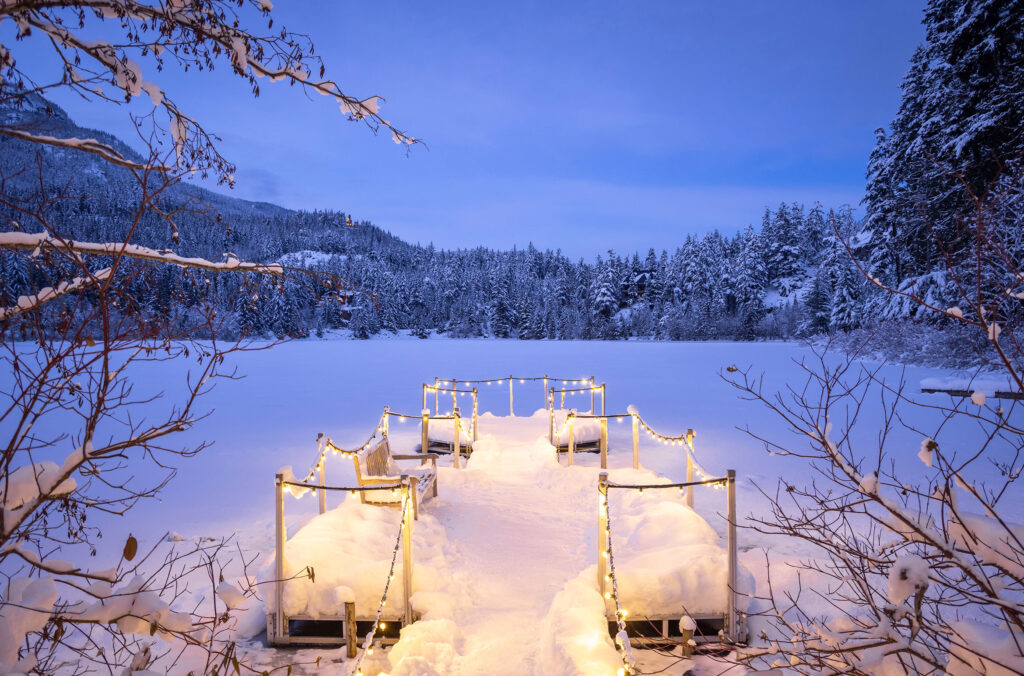 A lit walkway onto Nita Lake in Whistler in winter.