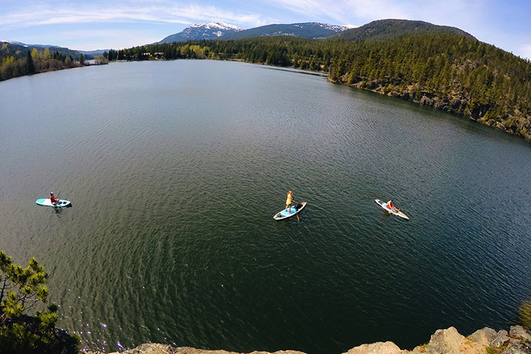 Paddle boarders enjoy the summer sun on Green Lake in Whistler.