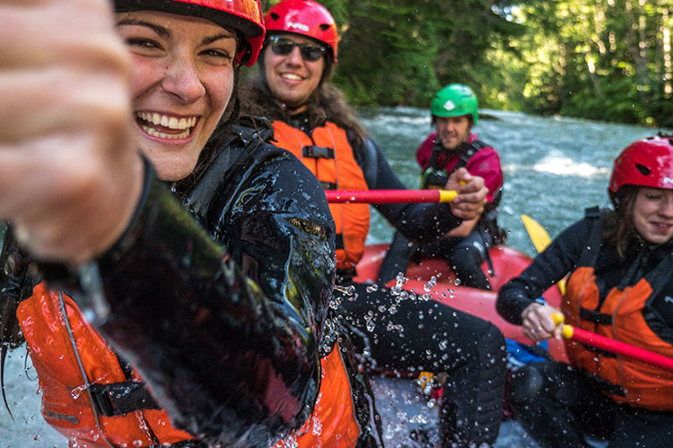 A group of people battle the whitewater on a rafting tour in Whistler.
