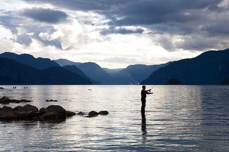 A fisherman casts in the early morning light in Squamish.