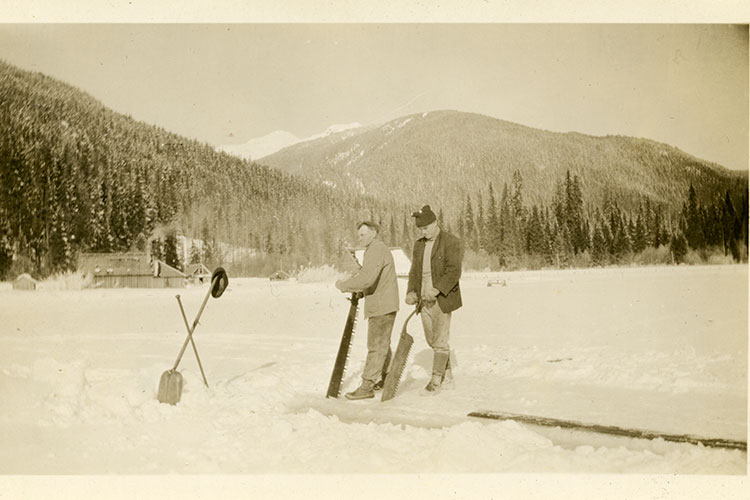 An archival photo of two men cutting ice on Alta Lake in 1917.