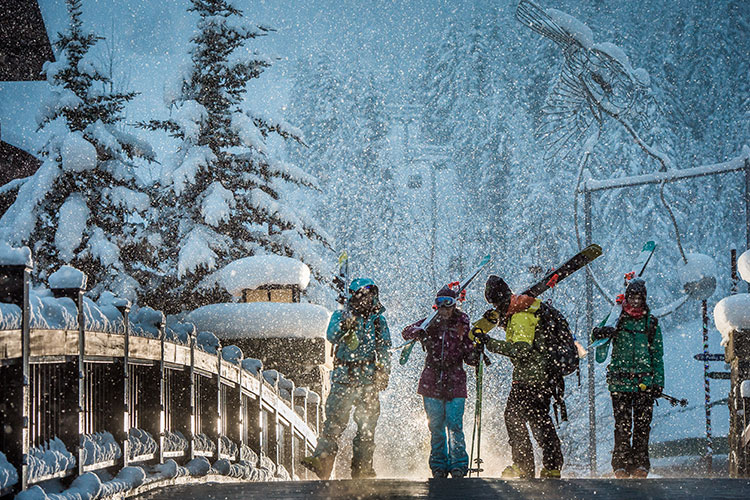 Skiers walking in Creekside