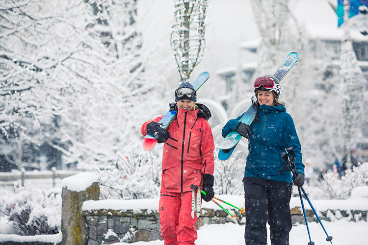 Skiers walking on a snowy Whistler Village Stroll