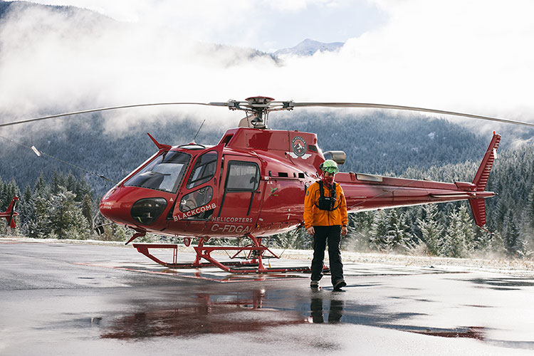 Mike Conway walks away from a helicopter in his Search & Rescue gear.