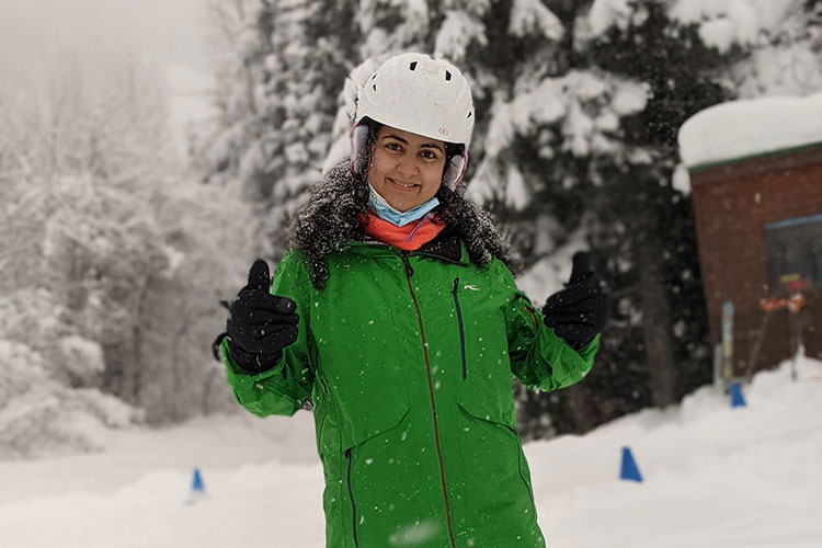 A skier gives the camera the thumbs up while on a beginner lesson on Whistler Mountain.