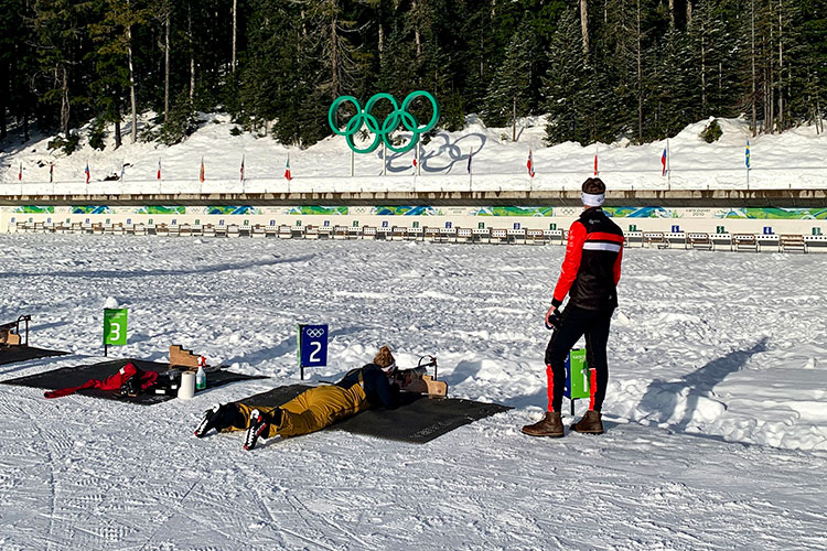 Amber lies prone on her belly taking a shot at the target at Whistler Olympic Park.