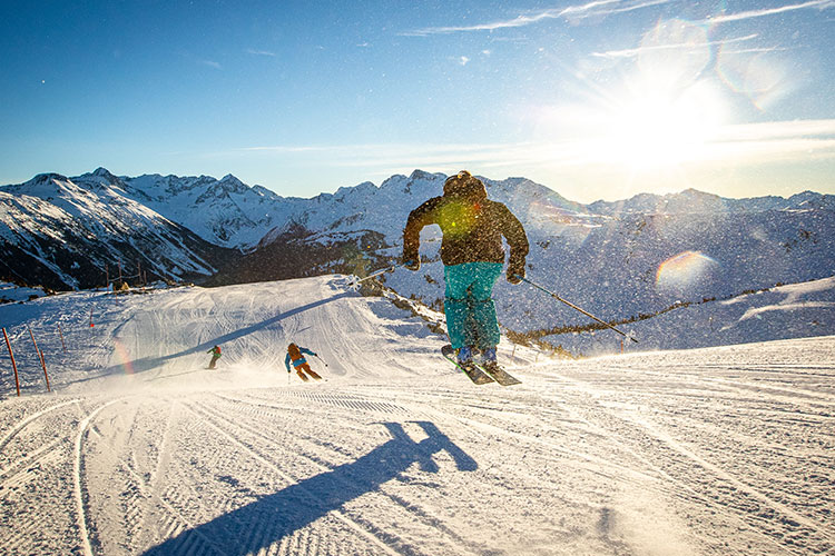 A group of skiers enjoy the fresh corduroy in Whistler.