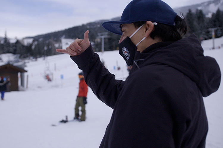 Court Larabee does the rock on hand symbol to his snowboarding students.