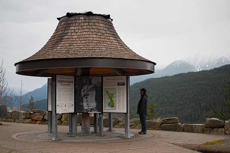 A man reads the information boards along Highway 99 on his way to Whistler.