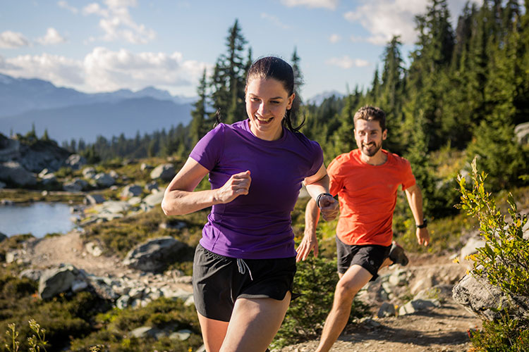 Two runners are in the high alpine in Whistler.